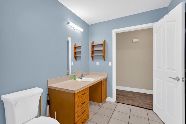 Bathroom featuring tile patterned floors, vanity, toilet, and baseboards | Image 27