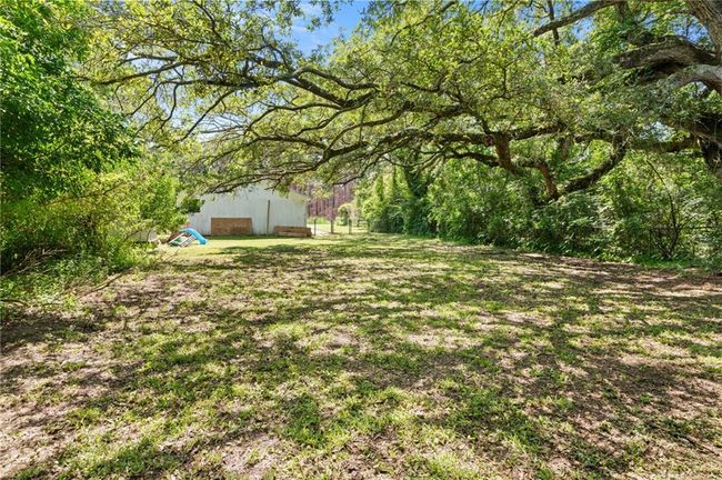 View of yard with a pole building and an outdoor structure | Image 21