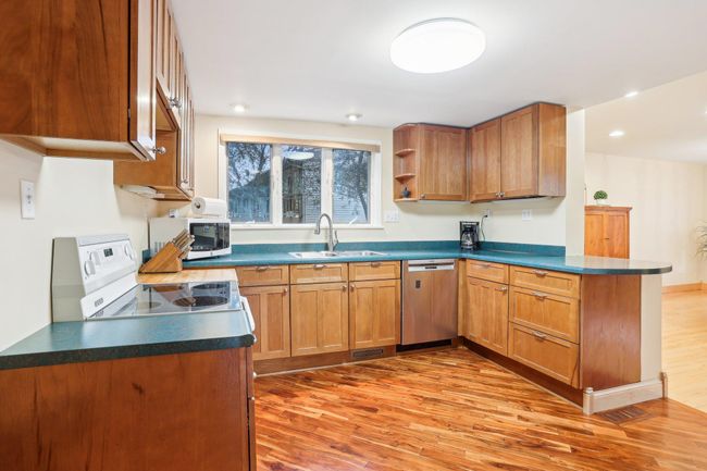 Kitchen sits just outside flex space with patio access | Image 8