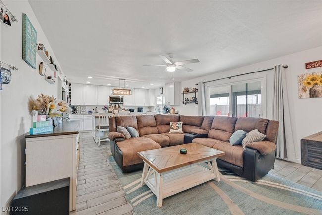 Living area featuring light wood-style flooring, recessed lighting, and ceiling fan | Image 12