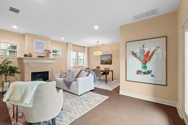 The living room flows seamlessly into the dining and kitchen area. | Image 12
