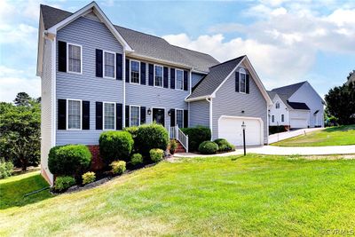 View of front of house with a front yard and a garage | Image 1