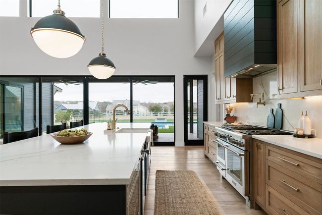 With an abundance of storage cleverly tucked away in custom cabinetry, this kitchen ensures you'll never be short on space, allowing you to keep your counters clear and your supplies perfectly organized | Image 13