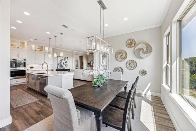 The dining area offers scenic backyard views and provides direct access to the covered patio. | Image 15