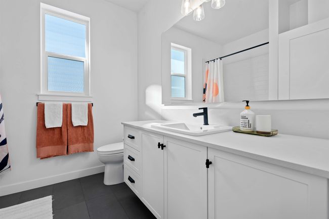 Bathroom with vanity, a shower with curtain, baseboards, tile patterned flooring, and toilet | Image 27