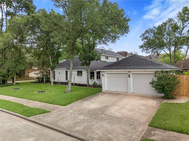 A clean driveway leading to a two-car garage. | Image 31