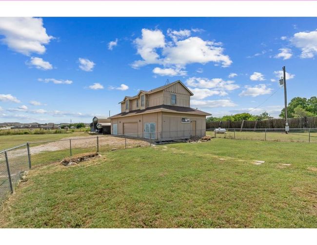 Fenced backyard featuring a garage | Image 29