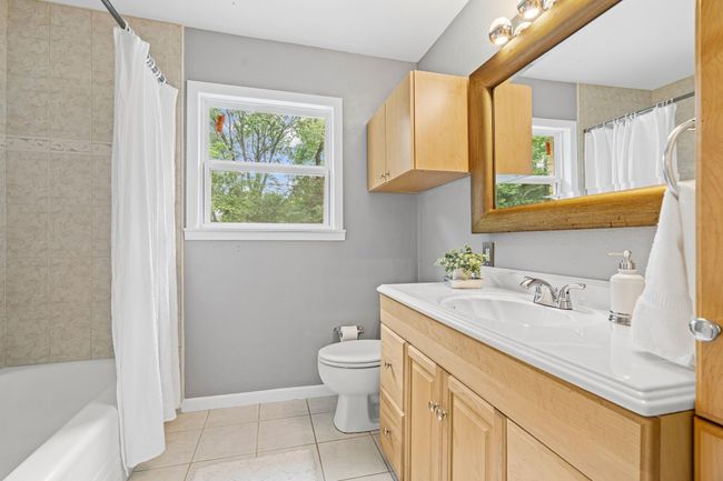 Bathroom featuring vanity, tile patterned floors, and shower / bathtub combination with curtain | Image 21