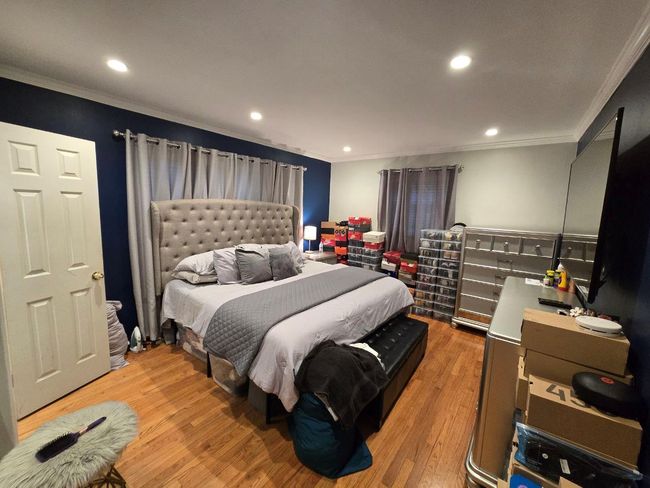 Bedroom with crown molding, light wood finished floors, and recessed lighting | Image 6