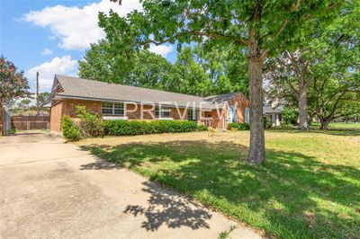 Ranch-style house featuring a front yard | Image 1