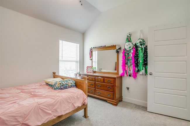Bedroom featuring lofted ceiling, light colored carpet, and baseboards | Image 29