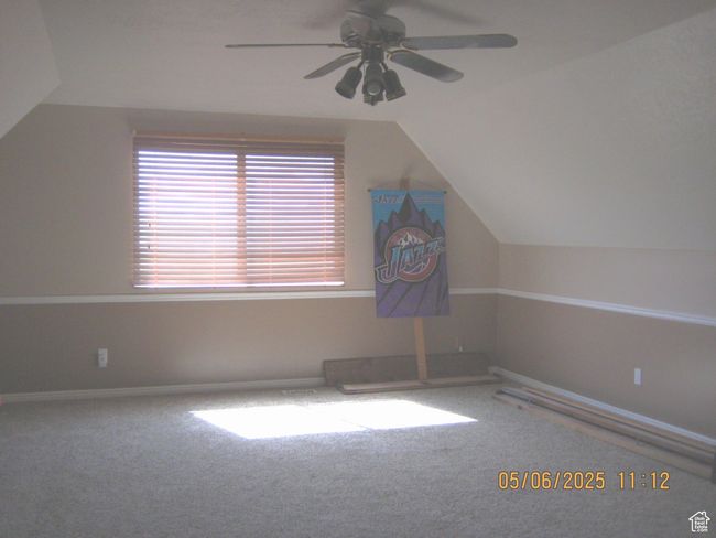 Bonus room featuring vaulted ceiling, ceiling fan, carpet flooring, and baseboards | Image 14