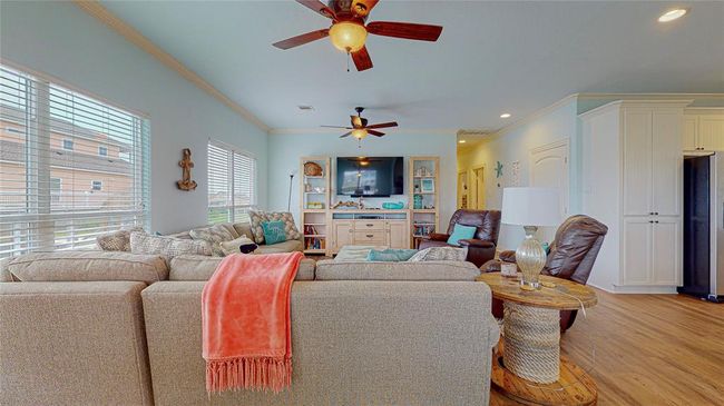 The family room is conveniently located off the kitchen, creating an open and inviting space for easy conversation and relaxation while you cook or entertain. | Image 12