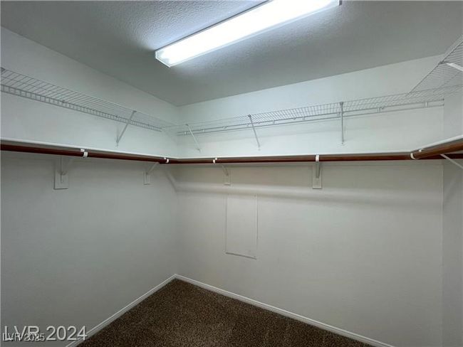 Walk in closet with dark carpet | Image 7