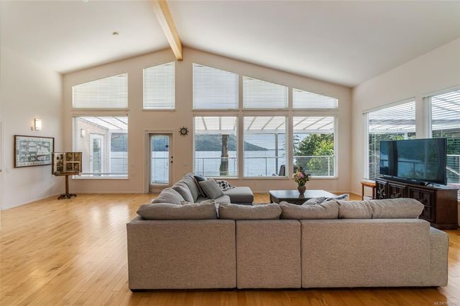 Living area featuring beam ceiling, high vaulted ceiling, and wood-type flooring | Image 25