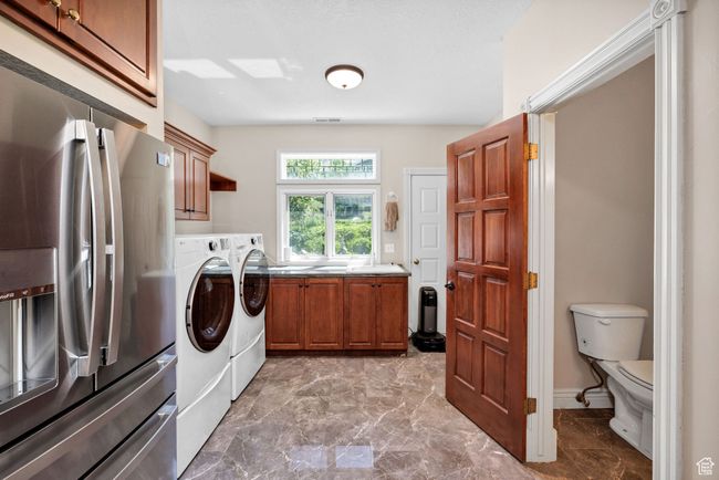 Washroom featuring washer and clothes dryer, marble finish flooring, and cabinet space | Image 14