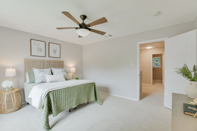 Bedroom featuring light carpet, ceiling fan, and attic access | Image 19