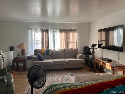 Living room with a healthy amount of sunlight and hardwood / wood-style floors | Image 2