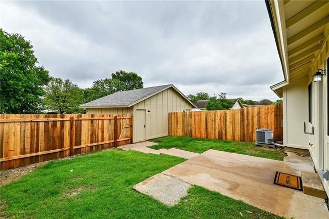 View of yard with central AC, a patio area, a shed, and an outdoor structure | Image 16