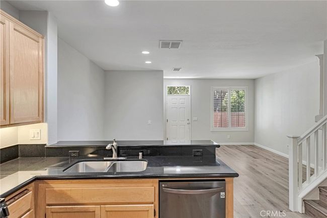 KITCHEN WITH STAINLESS APPLIANCES, BREAKFAST BAR AND PANTRY | Image 18