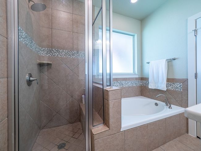 Bathroom featuring a garden tub, a shower stall, and tile patterned flooring | Image 16