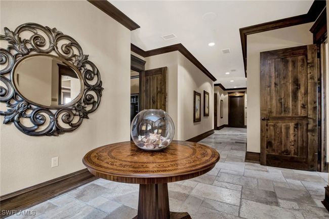 Hall with ornamental molding, stone tile floors, and recessed lighting | Image 42