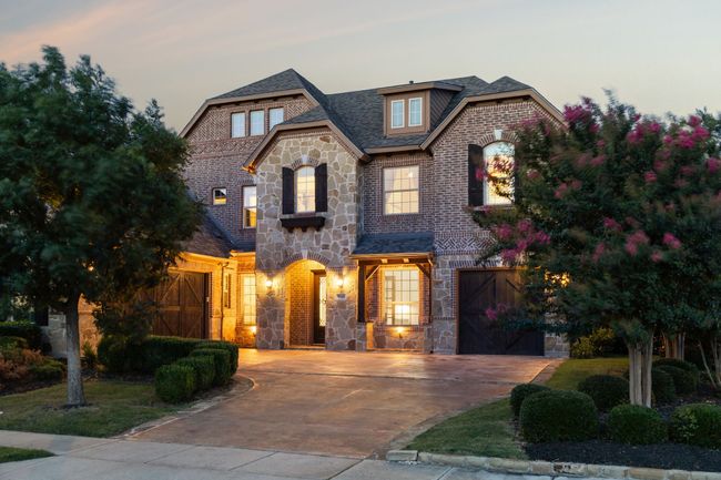 French country inspired facade featuring stone siding, driveway, brick siding, and roof with shingles | Image 31