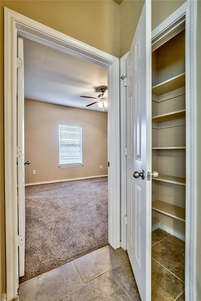 Hallway featuring carpet floors and tile patterned flooring | Image 12