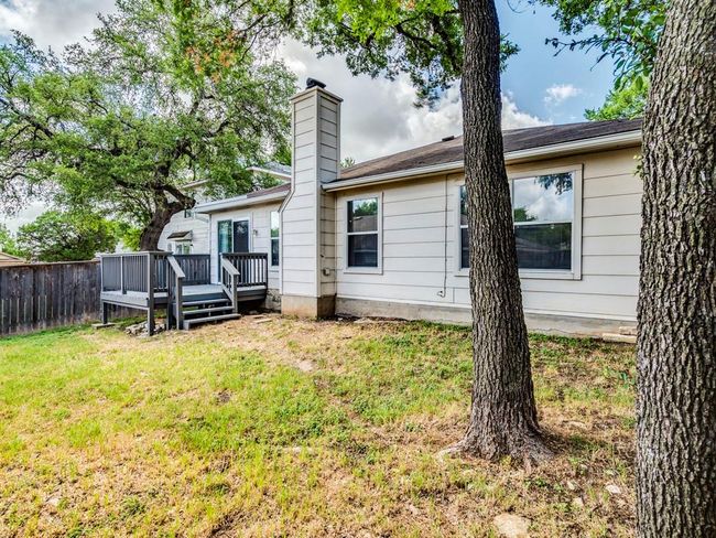 Back of property featuring a wooden deck and a chimney | Image 28