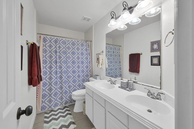 Full bathroom upstairs offers dual sinks, ideal for sharing. | Image 29