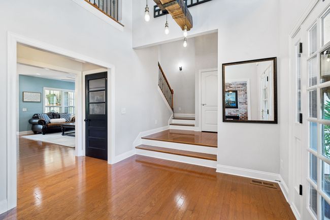 Welcoming foyer with vaulted ceilings and custom light fixture. | Image 34