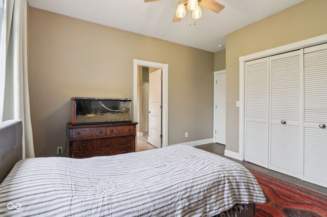 bedroom featuring baseboards, a closet, wood finished floors, and ceiling fan | Image 40