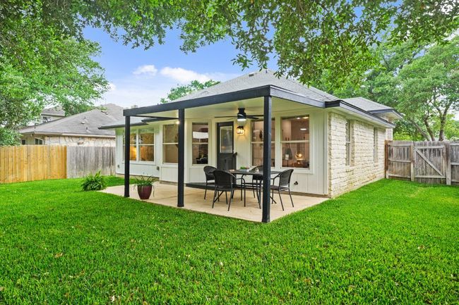 The backyard offers a peaceful space with easy access to the covered patio—ideal for outdoor relaxation and entertaining. 9349 Bernoulli Dr., Austin, TX 78748 | Image 30