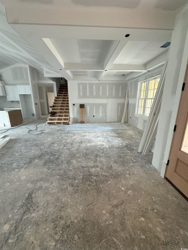 Unfurnished living room with stairway and coffered ceiling | Image 29