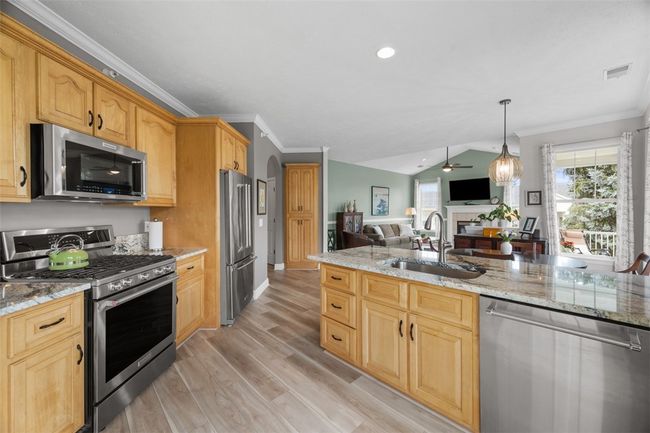 Granite countertops and stainless steel Kitchenaid appliances including a gas cooktop with convection oven are well appreciated. | Image 16