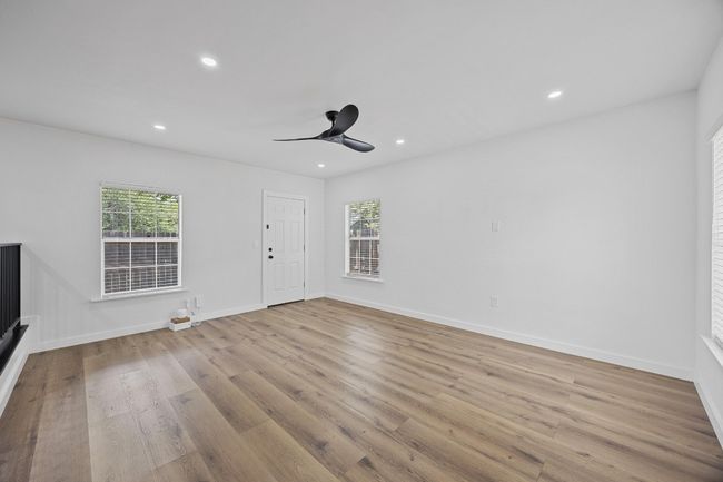 Unfurnished living room featuring wood finished floors, recessed lighting, and ceiling fan | Image 12