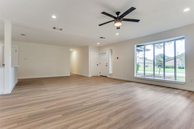 Unfurnished living room featuring light wood-style flooring, recessed lighting, ceiling fan, and baseboards | Image 7