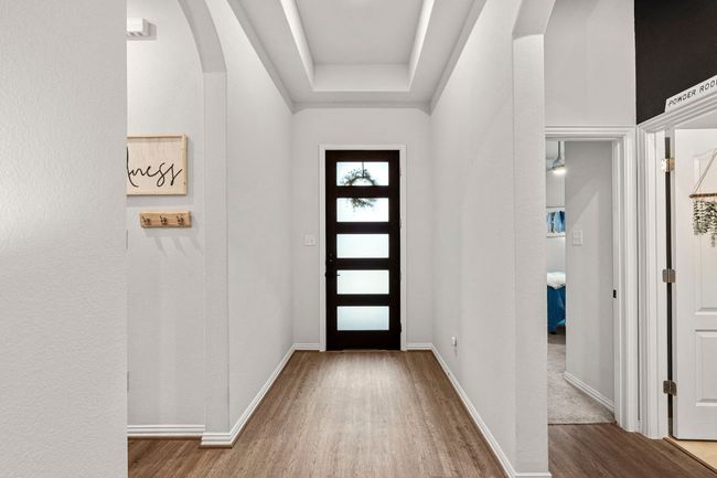 Entryway featuring wood finished floors, arched walkways, and baseboards | Image 7