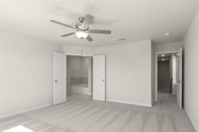 Unfurnished bedroom featuring visible vents, baseboards, connected bathroom, and light colored carpet | Image 19