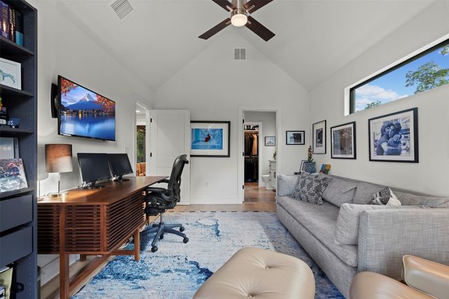 Office space with a ceiling fan, high vaulted ceiling, wood finished floors, and healthy amount of natural light | Image 33