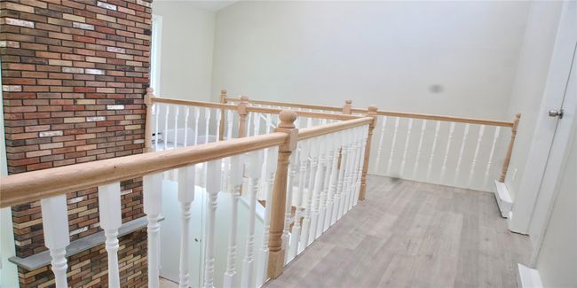Hallway featuring an upstairs landing and light wood-style floors | Image 38