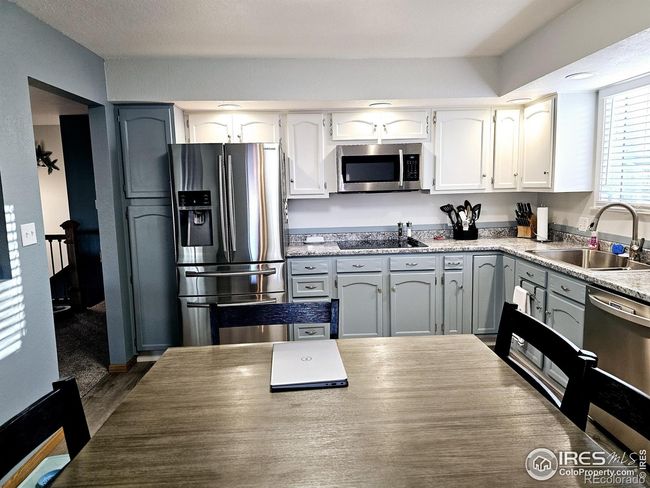 Kitchen with painted cabinets and updated flooring is 13 x 12 | Image 7
