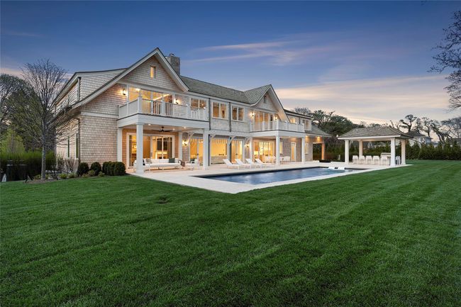 Rear view of property featuring a patio, a chimney, a gazebo, and a balcony | Image 49