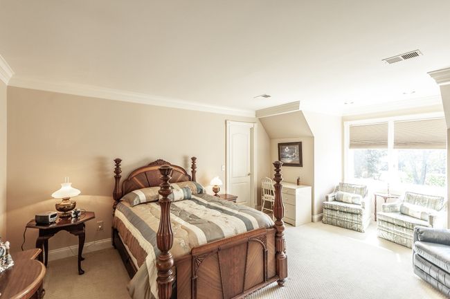 This upstairs bedroom features a walk-in closet, beautiful natural light, and is connected to the Jack and Jill bathroom. | Image 44