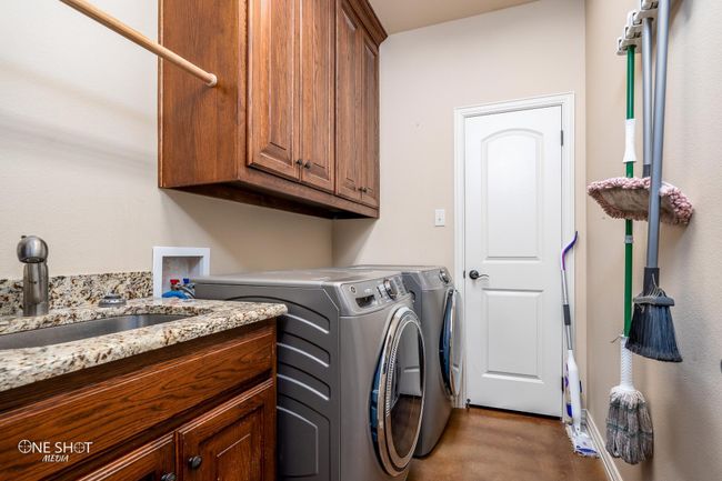 Clothes washing area with cabinet space and washer and dryer | Image 34