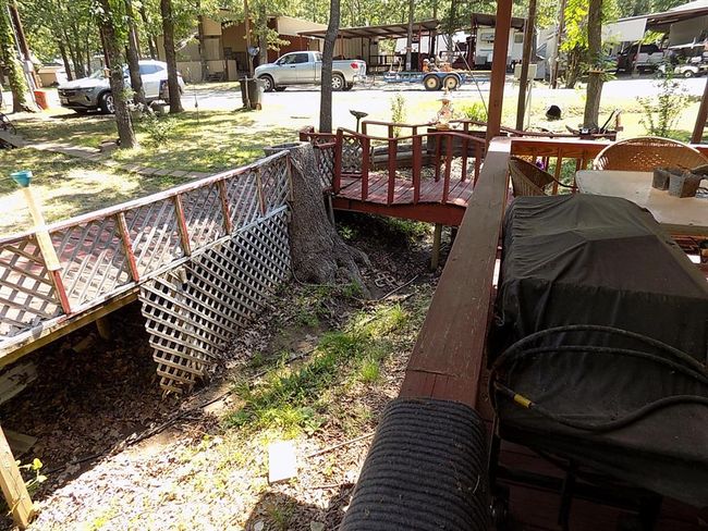 View of yard, bridge and decking over natural drainage. | Image 12