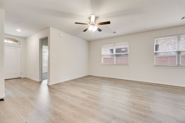 Unfurnished room with plenty of natural light, ceiling fan, light wood-style flooring, and baseboards | Image 11