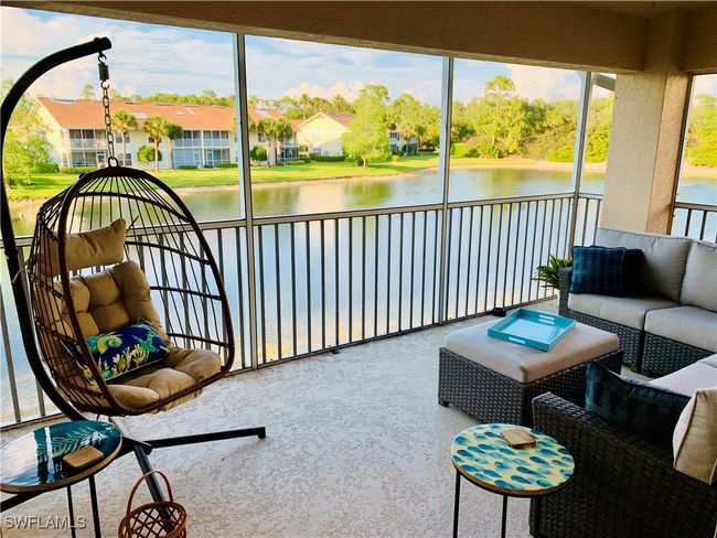 Sunroom featuring outdoor lounge area and a water view | Image 6