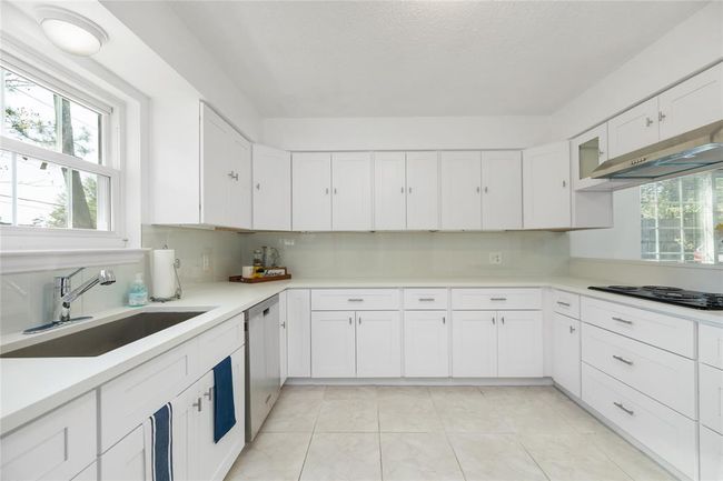 New updated kitchen, with cabinets, counter tops, stove, and sink | Image 17