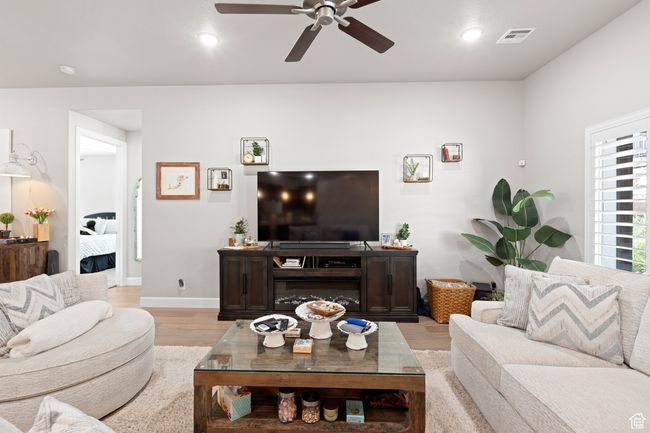 Living area with a ceiling fan, light wood-style floors, and recessed lighting | Image 53